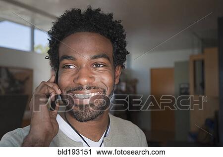 Stock Image - Black man talking on cell phone. Fotosearch