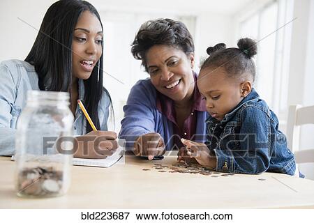 Black multi-generation family counting coins View Large Photo Image Stock Photo - Black multi-generation family counting coins. Fotosearch