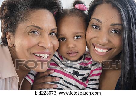 Black multi-generation family posing cheek to cheek View Large Photo Image Stock Image - Black multi-generation family posing cheek to cheek. Fotosearch