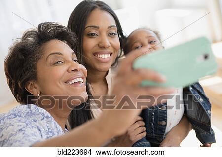 Black multi-generation family talking selfie View Large Photo Image Picture - Black multi-generation family talking selfie. Fotosearch