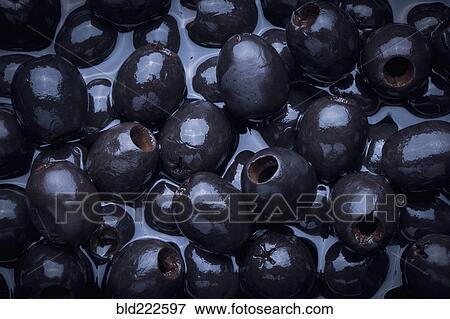 Stock Photo - Black olives in liquid. Fotosearch