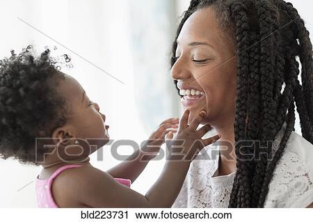 Black woman playing with baby daughter View Large Photo Image Stock Image - Black woman playing with baby daughter. Fotosearch