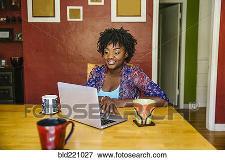 Stock Photo - Black woman using laptop. Fotosearch