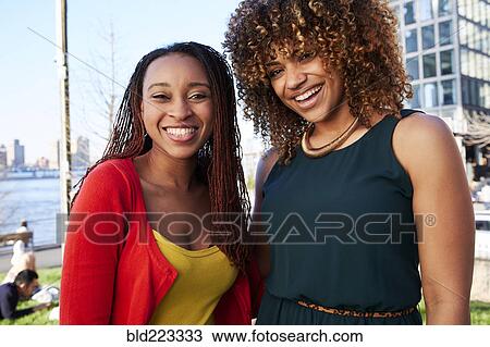 Black women smiling at waterfront View Large Photo Image Stock Image - Black women smiling at waterfront. Fotosearch