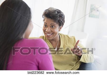 Black women talking View Large Photo Image Stock Image - Black women talking. Fotosearch
