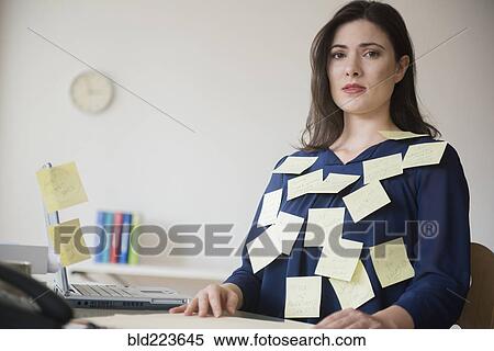 Stock Photography - Blouse of stressed Caucasian businesswoman covered with adhesive notes. Fotosearch