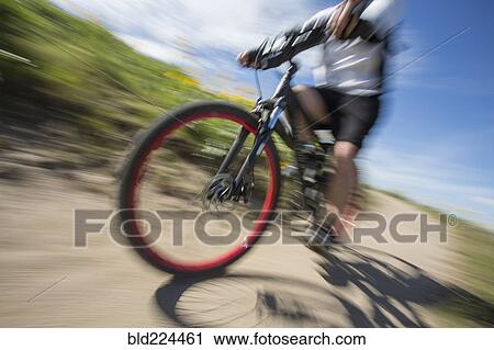 Blurred view of man riding mountain bike View Large Photo Image Stock Image - Blurred view of man riding mountain bike. Fotosearch
