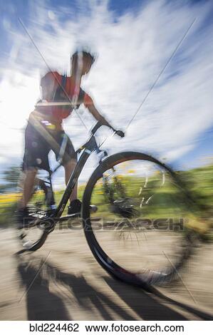 Blurred view of man riding mountain bike View Large Photo Image Stock Image - Blurred view of man riding mountain bike. Fotosearch