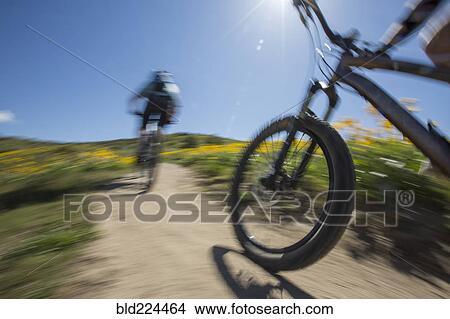 Blurred view of men riding mountain bikes View Large Photo Image Picture - Blurred view of men riding mountain bikes. Fotosearch