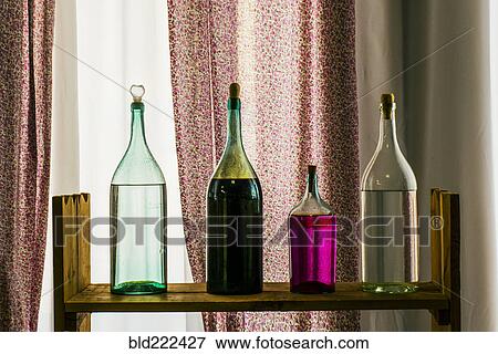 Stock Photo - Bottles on shelf near window. Fotosearch
