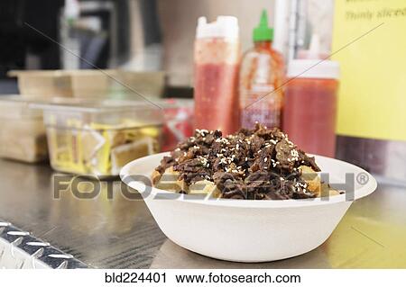Stock Image - Bowl of food on shelf of food truck. Fotosearch