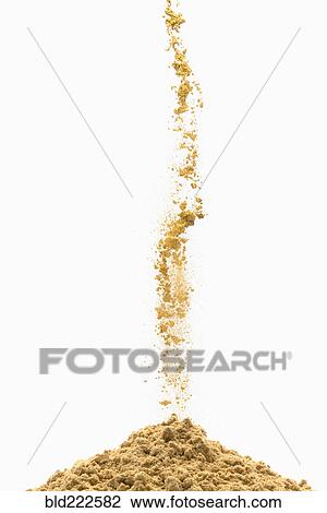 Stock Image - Brown powder pouring into pile. Fotosearch