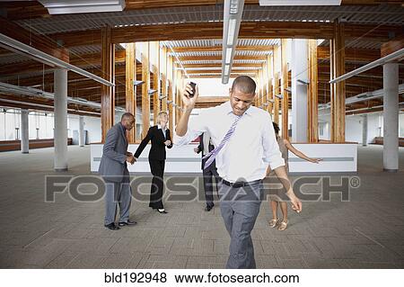 Business people dancing in empty office space View Large Photo Image Stock Photo - Business people dancing in empty office space. Fotosearch