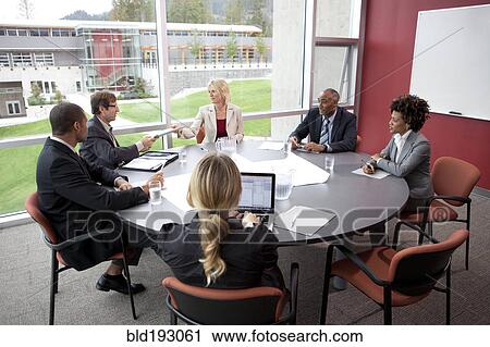 Stock Image - Business people in meeting in conference room. Fotosearch