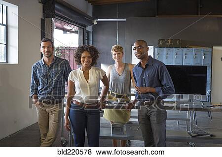 Business people smiling in office View Large Photo Image Stock Photo - Business people smiling in office. Fotosearch