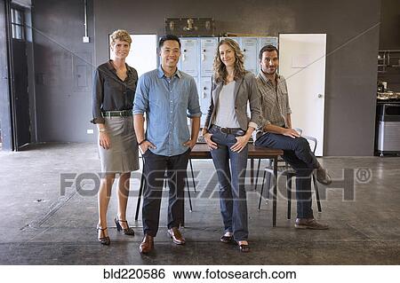 Business people smiling in office View Large Photo Image Stock Photograph - Business people smiling in office. Fotosearch