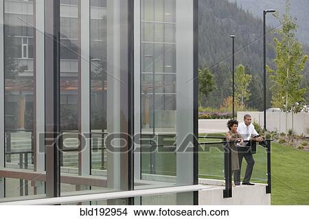 Picture - Business people standing on balcony. Fotosearch