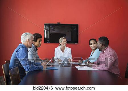 Stock Photograph - Business people talking in conference room meeting. Fotosearch