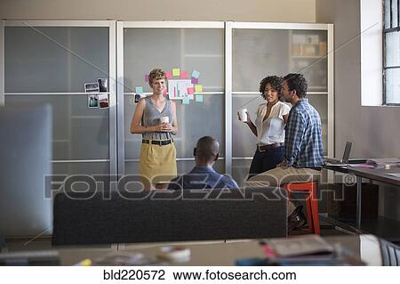 Stock Image - Business people talking in office. Fotosearch