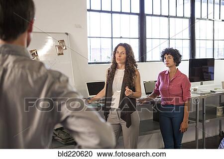 Business people talking in office View Large Photo Image Stock Image - Business people talking in office. Fotosearch