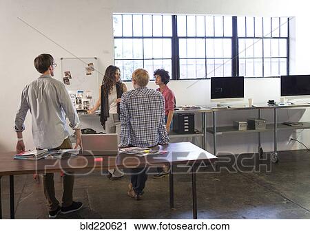Stock Image - Business people talking in office. Fotosearch