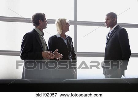 Stock Photo - Business people talking in office. Fotosearch