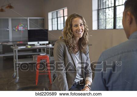 Business people talking in office View Large Photo Image Stock Photo - Business people talking in office. Fotosearch