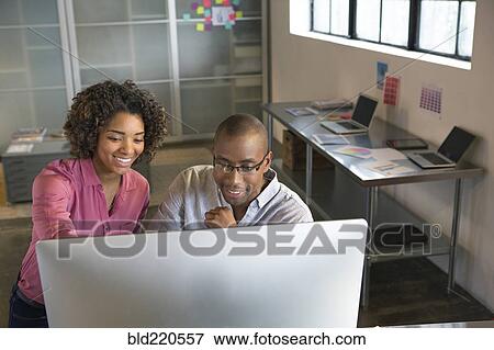 Business people using computer in office View Large Photo Image Stock Photo - Business people using computer in office. Fotosearch