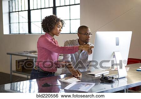 Stock Photograph - Business people using computer in office. Fotosearch