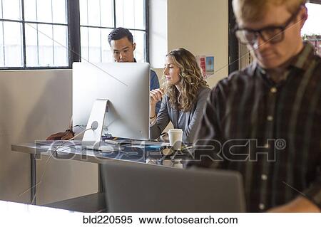 Stock Photography - Business people working in office. Fotosearch