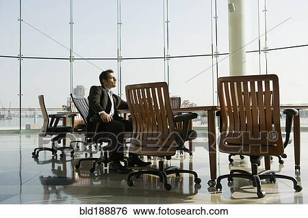 Businessman waiting in conference room for meeting View Large Photo Image Stock Photograph - Businessman waiting in conference room for meeting. Fotosearch