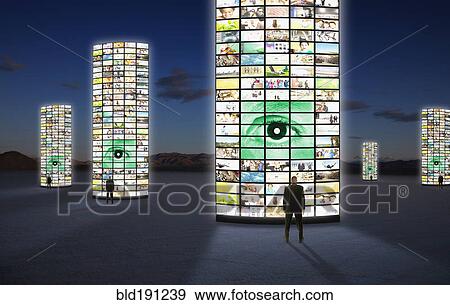 Stock Photo - Businessmen standing next to pillars of television screens. Fotosearch