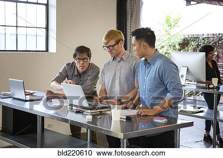 Businessmen talking in office View Large Photo Image Stock Image - Businessmen talking in office. Fotosearch
