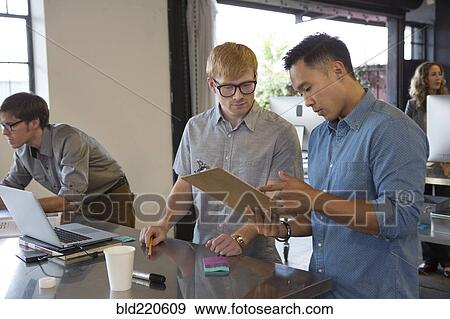 Businessmen talking in office View Large Photo Image Stock Photo - Businessmen talking in office. Fotosearch