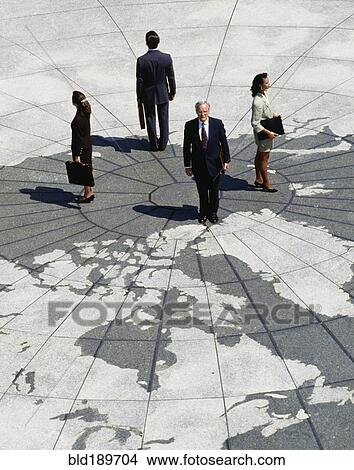 Businesspeople standing on map of globe View Large Photo Image Picture - Businesspeople standing on map of globe. Fotosearch