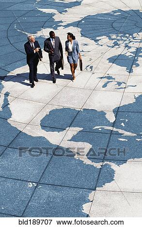 Businesspeople walking on map of globe View Large Photo Image Stock Photo - Businesspeople walking on map of globe. Fotosearch