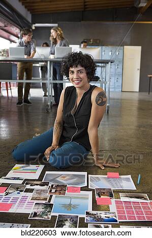 Businesswoman examining paperwork on office floor View Large Photo Image Stock Image - Businesswoman examining paperwork on office floor. Fotosearch