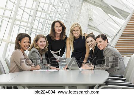 Picture - Businesswomen posing in conference room. Fotosearch