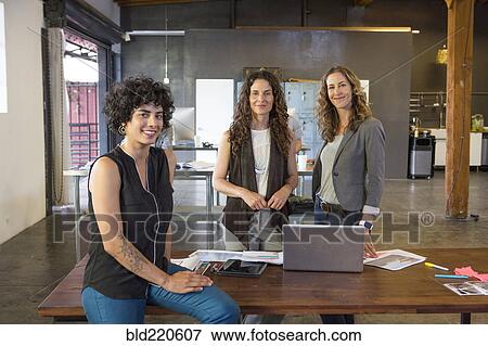 Stock Photo - Businesswomen smiling in office. Fotosearch