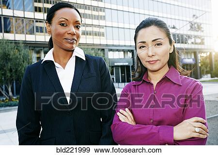 Stock Photo - Businesswomen standing outdoors. Fotosearch
