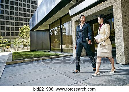 Stock Photograph - Businesswomen talking outdoors. Fotosearch