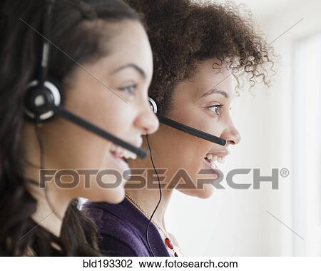 Stock Image - Businesswomen working in call center. Fotosearch