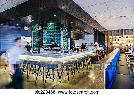 Busy Caucasian workers at counter in modern bar and restaurant View Large Photo Image Stock Photo - Busy Caucasian workers at counter in modern bar and restaurant. Fotosearch
