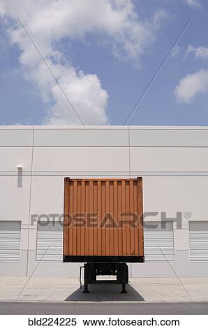 Stock Photography - Cargo container at loading dock under blue sky. Fotosearch