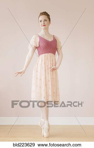 Stock Photo - Caucasian ballerina standing en pointe. Fotosearch