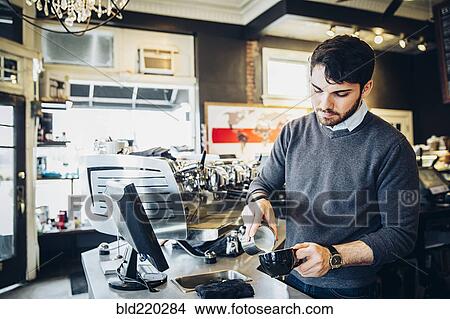 Caucasian barista making coffee in cafe View Large Photo Image Picture - Caucasian barista making coffee in cafe. Fotosearch