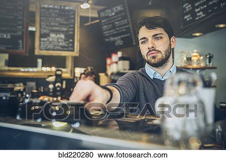 Caucasian barista making coffee in cafe View Large Photo Image Stock Image - Caucasian barista making coffee in cafe. Fotosearch