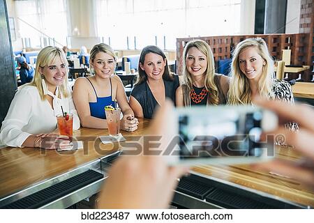 Caucasian bartender taking cell phone photograph of customers View Large Photo Image Stock Photo - Caucasian bartender taking cell phone photograph of customers. Fotosearch