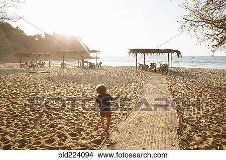 Caucasian boy following path to beach View Large Photo Image Picture - Caucasian boy following path to beach. Fotosearch