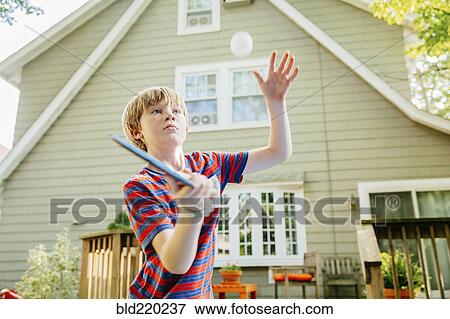 Caucasian boy playing table tennis in backyard View Large Photo Image Stock Photo - Caucasian boy playing table tennis in backyard. Fotosearch
